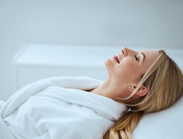 Side view of a serene lady relaxing before a beauty procedure in a spa salon